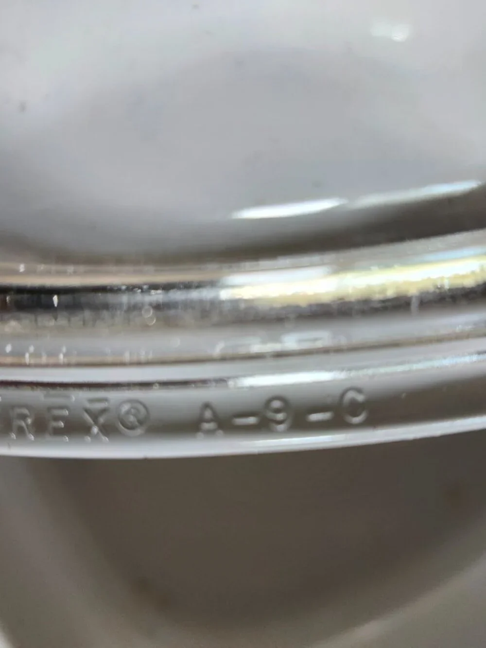 Three CorningWare casserole dishes with lids